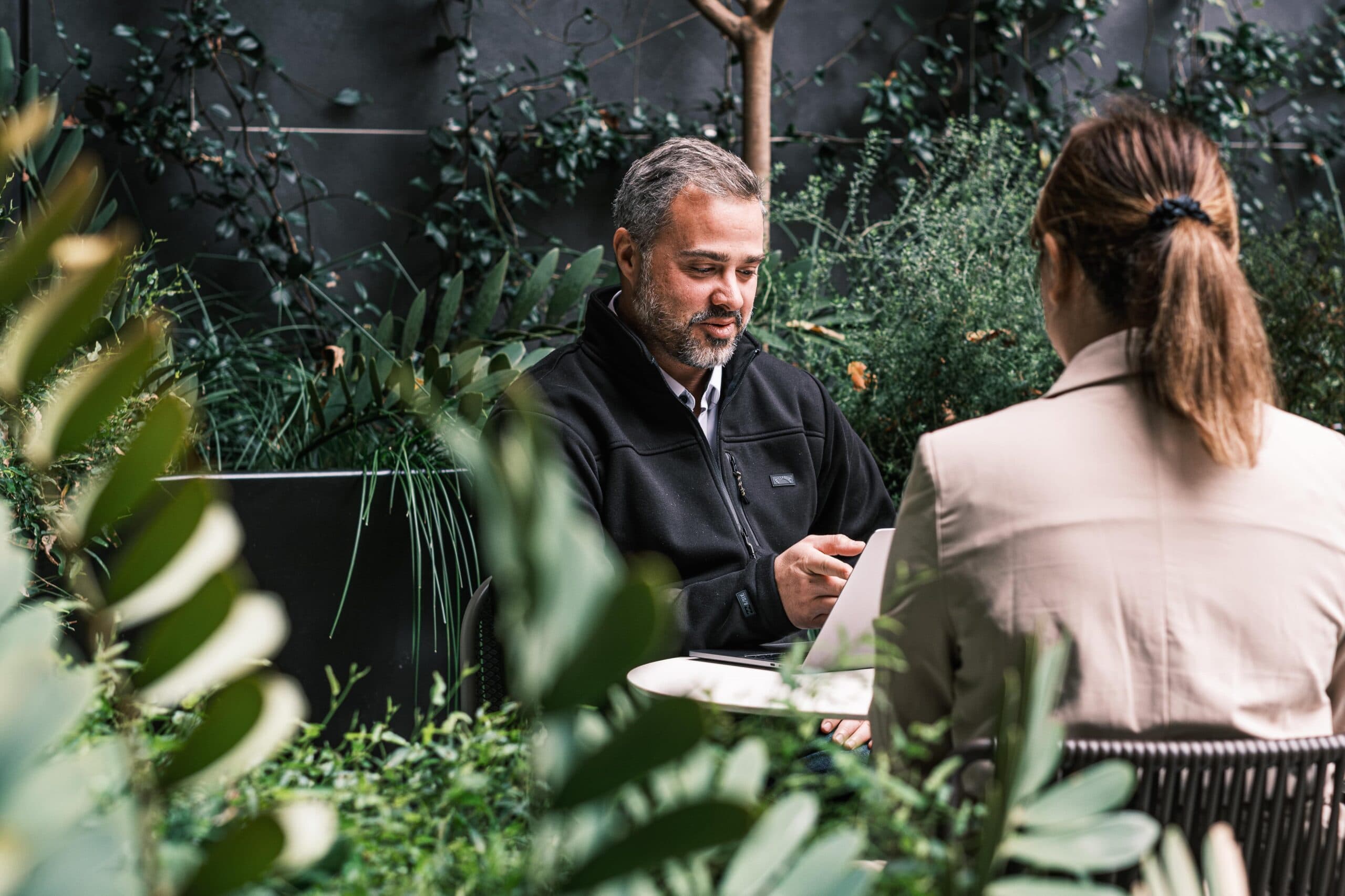Customer retention strategy at a leafy cafe, with two seated customers